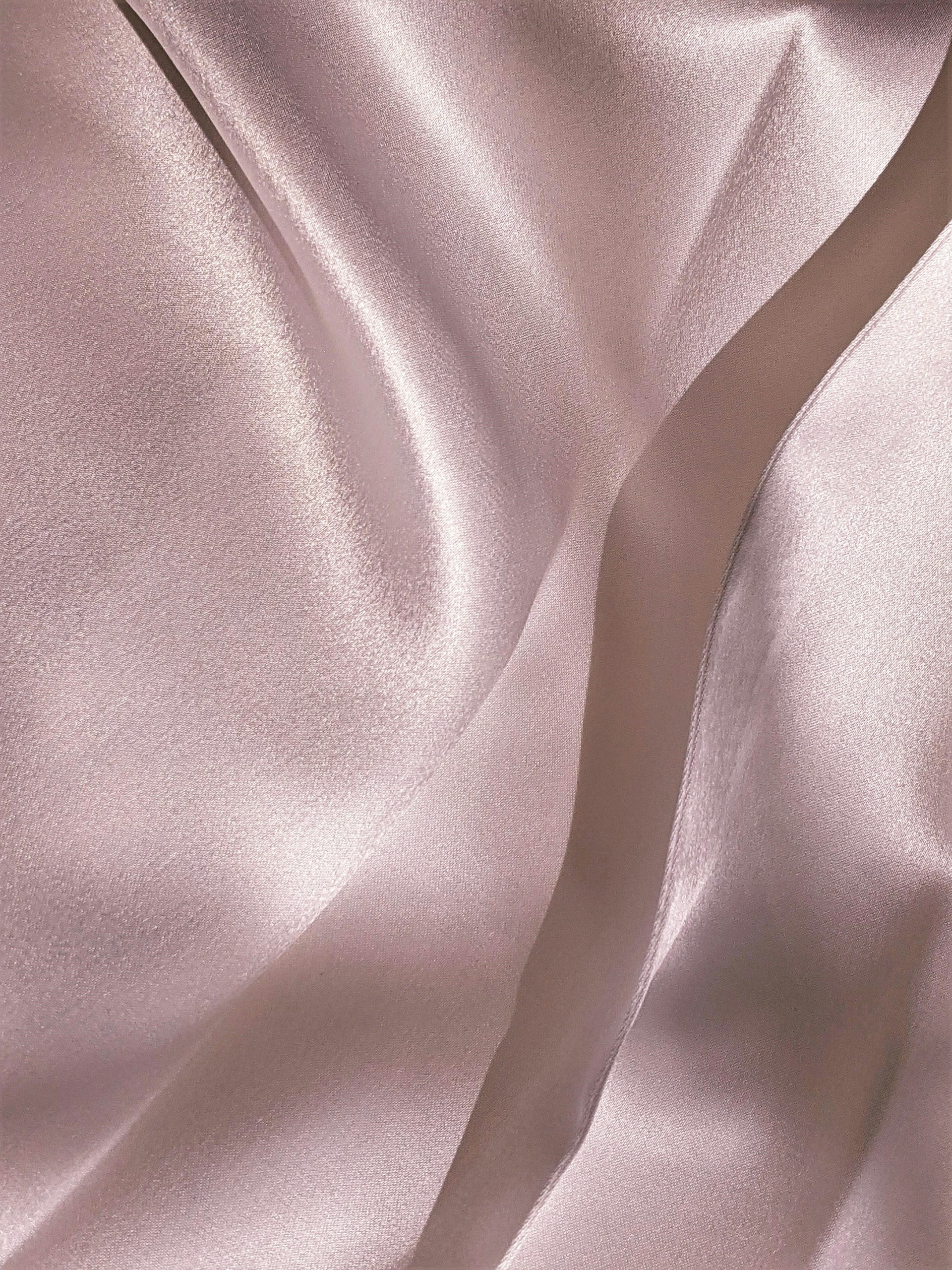 Soft pink silk folds representing the delicate feminine fragrance of Kashmir Spirit perfume by ScentSociety