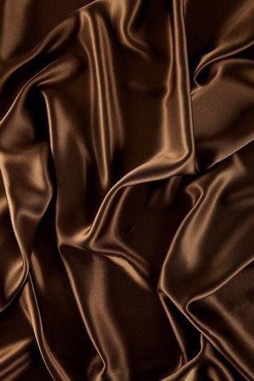 Luxurious dark brown silk texture representing the elegance of Tropic Blanc (Sicilian Sun) perfume by ScentSociety