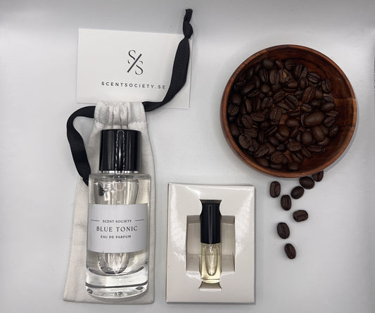 Perfume bottle and gift set with coffee beans representing rich cherry and spicy notes of Blue Tonic fragrance by ScentSociety