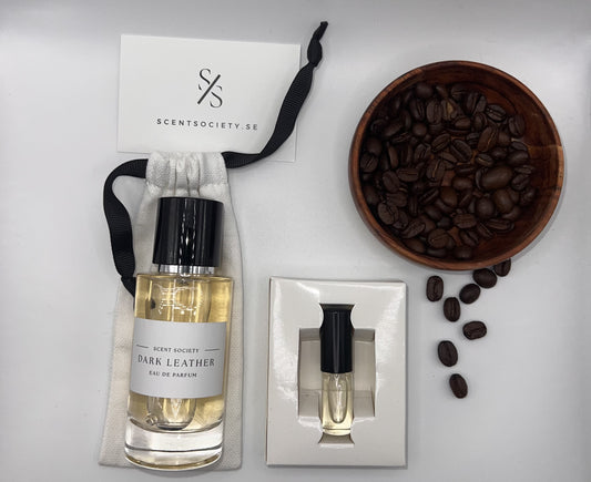 Perfume bottle and gift set with coffee beans representing rich cherry and spicy notes of Dark Leather fragrance by ScentSociety