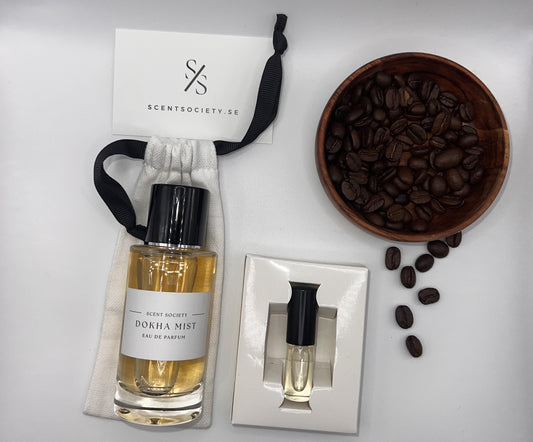 Perfume bottle and gift set with coffee beans representing rich cherry and spicy notes of Dokha Mist fragrance by ScentSociety