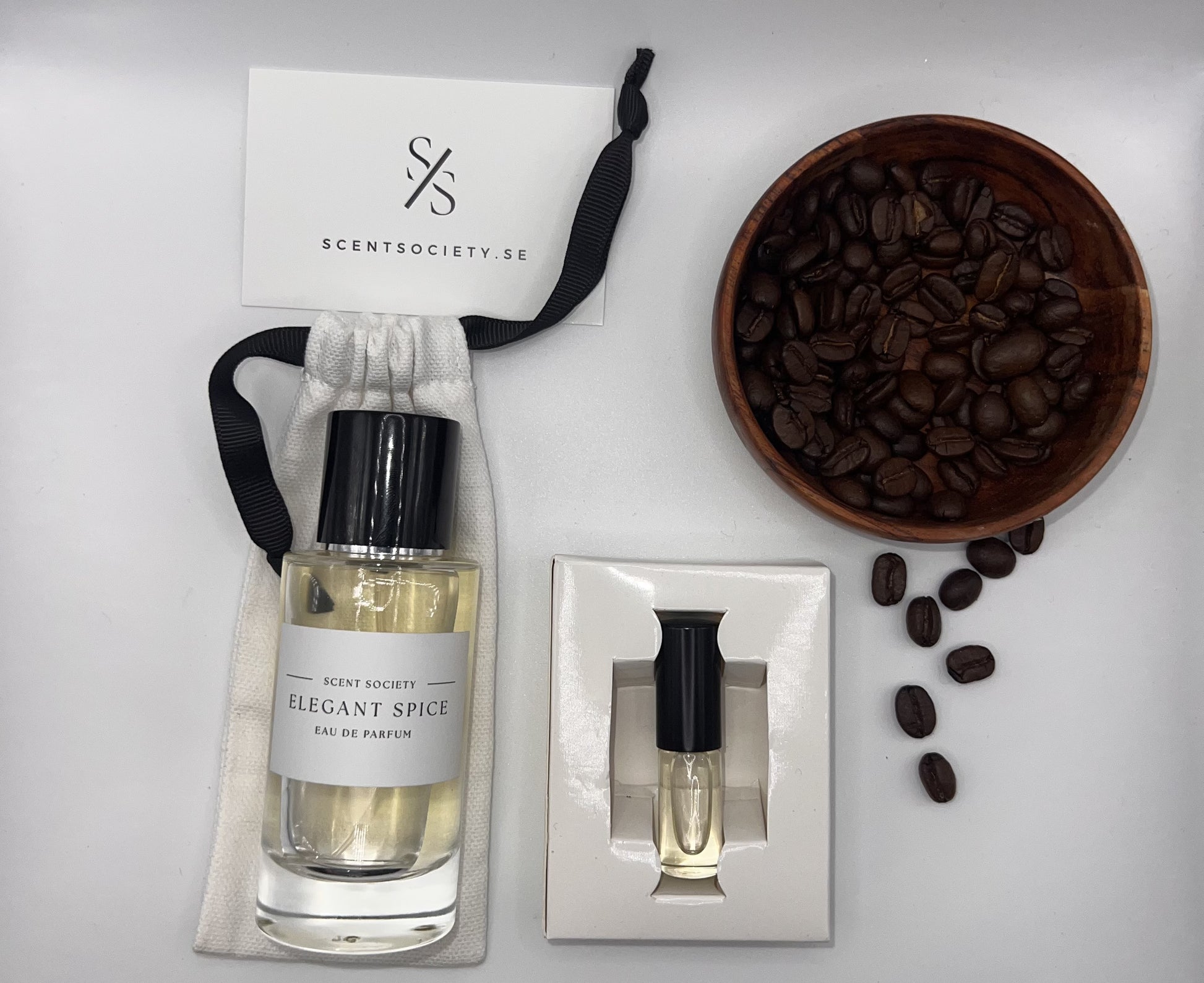 Perfume bottle and gift set with coffee beans representing rich cherry and spicy notes of Elegant Spice fragrance by ScentSociety