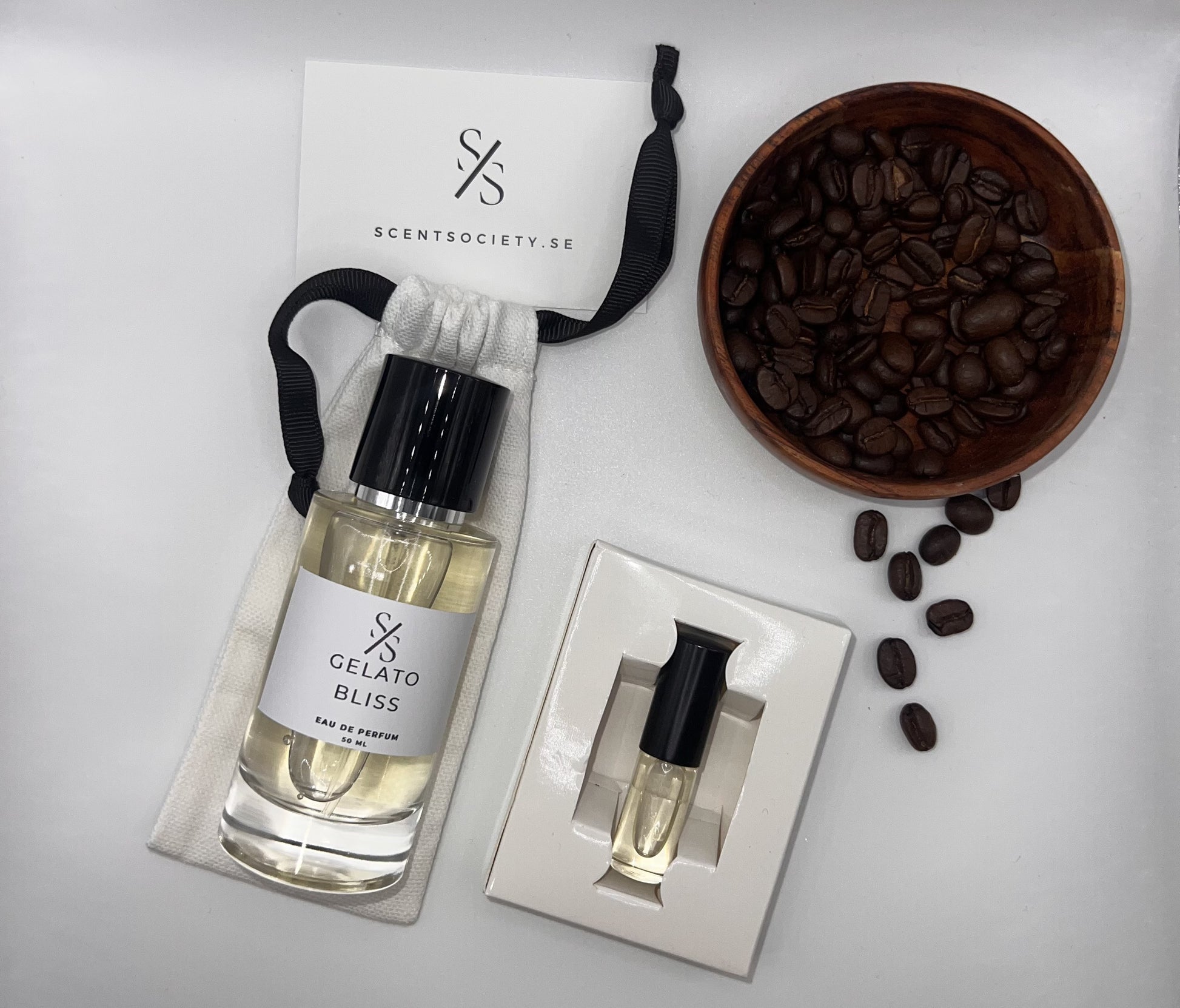 Perfume bottle and gift set with coffee beans representing rich cherry and spicy notes of Gelato Bliss fragrance by ScentSociety