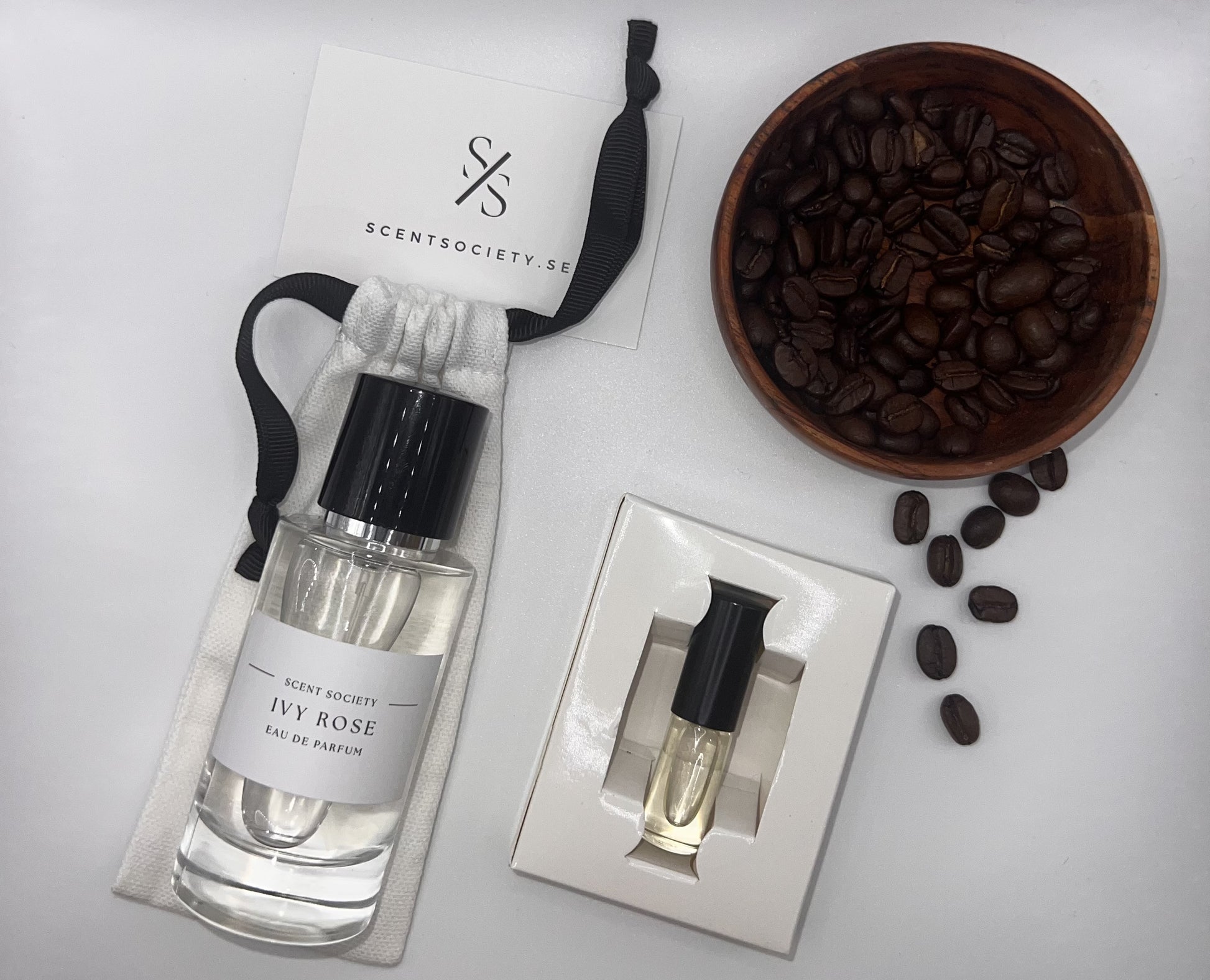 Perfume bottle and gift set with coffee beans representing rich cherry and spicy notes of Ivy Rose fragrance by ScentSociety