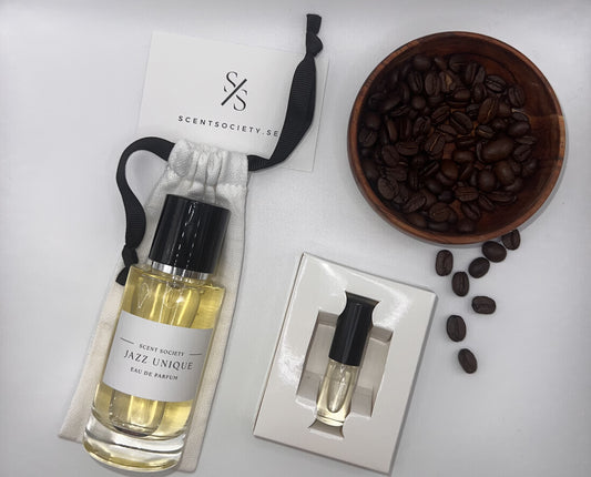 Perfume bottle and gift set with coffee beans representing rich cherry and spicy notes of Jazz Unique fragrance by ScentSociety