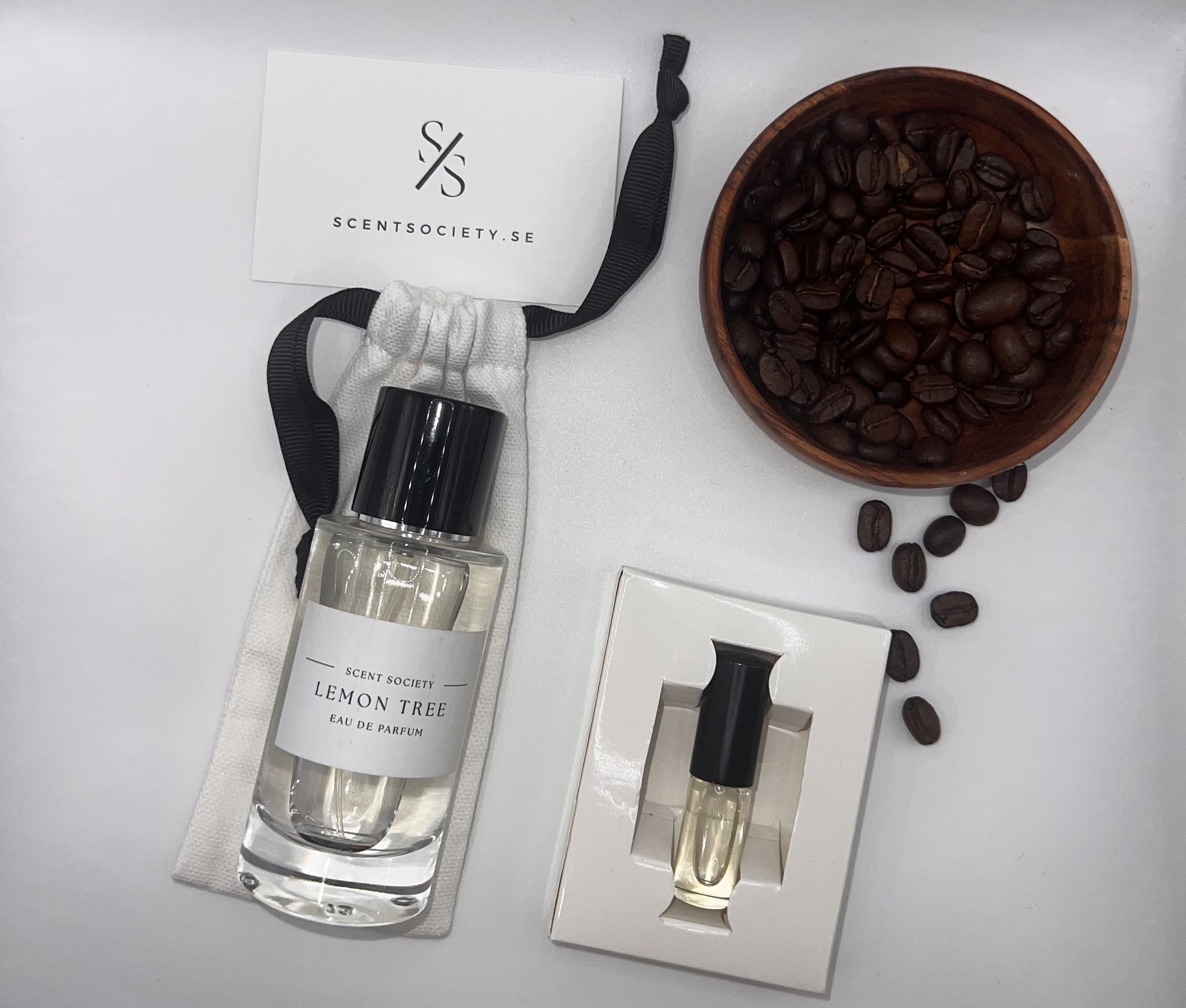 Perfume bottle and gift set with coffee beans representing rich cherry and spicy notes of Lemon Tree fragrance by ScentSociety