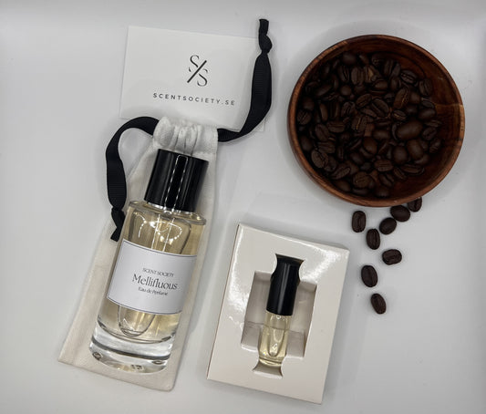 Perfume bottle and gift set with coffee beans representing rich cherry and spicy notes of Melliflous fragrance by ScentSociety