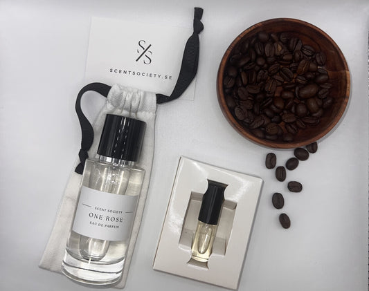 Perfume bottle and gift set with coffee beans representing rich cherry and spicy notes of One Rose fragrance by ScentSociety