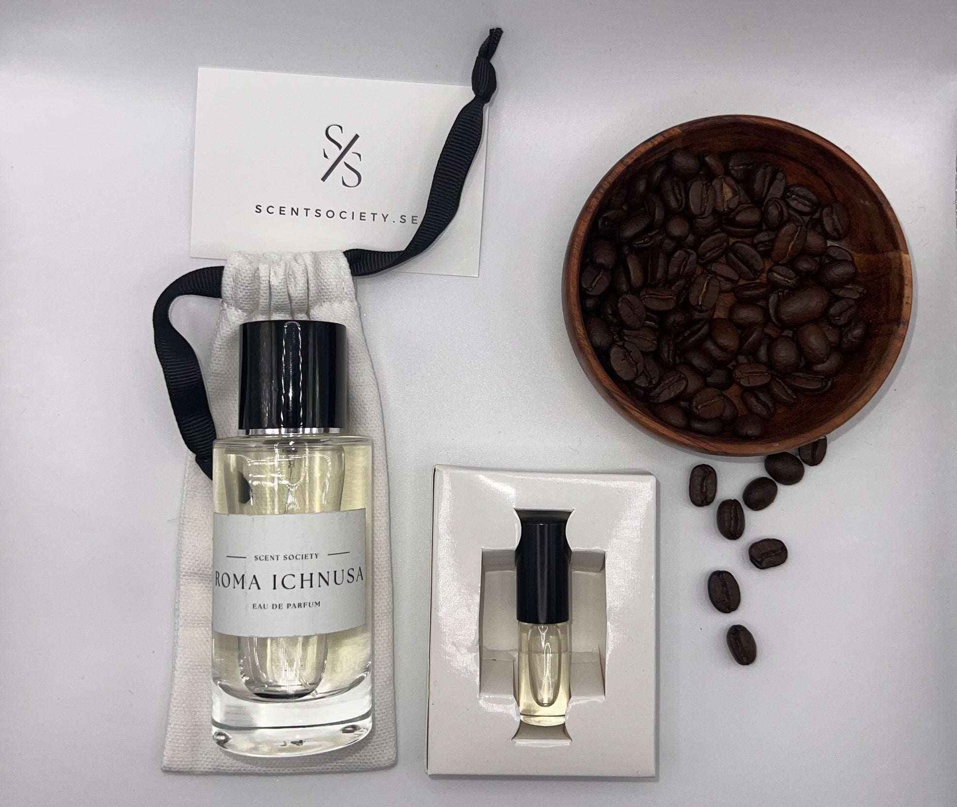 Perfume bottle and gift set with coffee beans representing rich cherry and spicy notes of Roma Ichnusa fragrance by ScentSociety