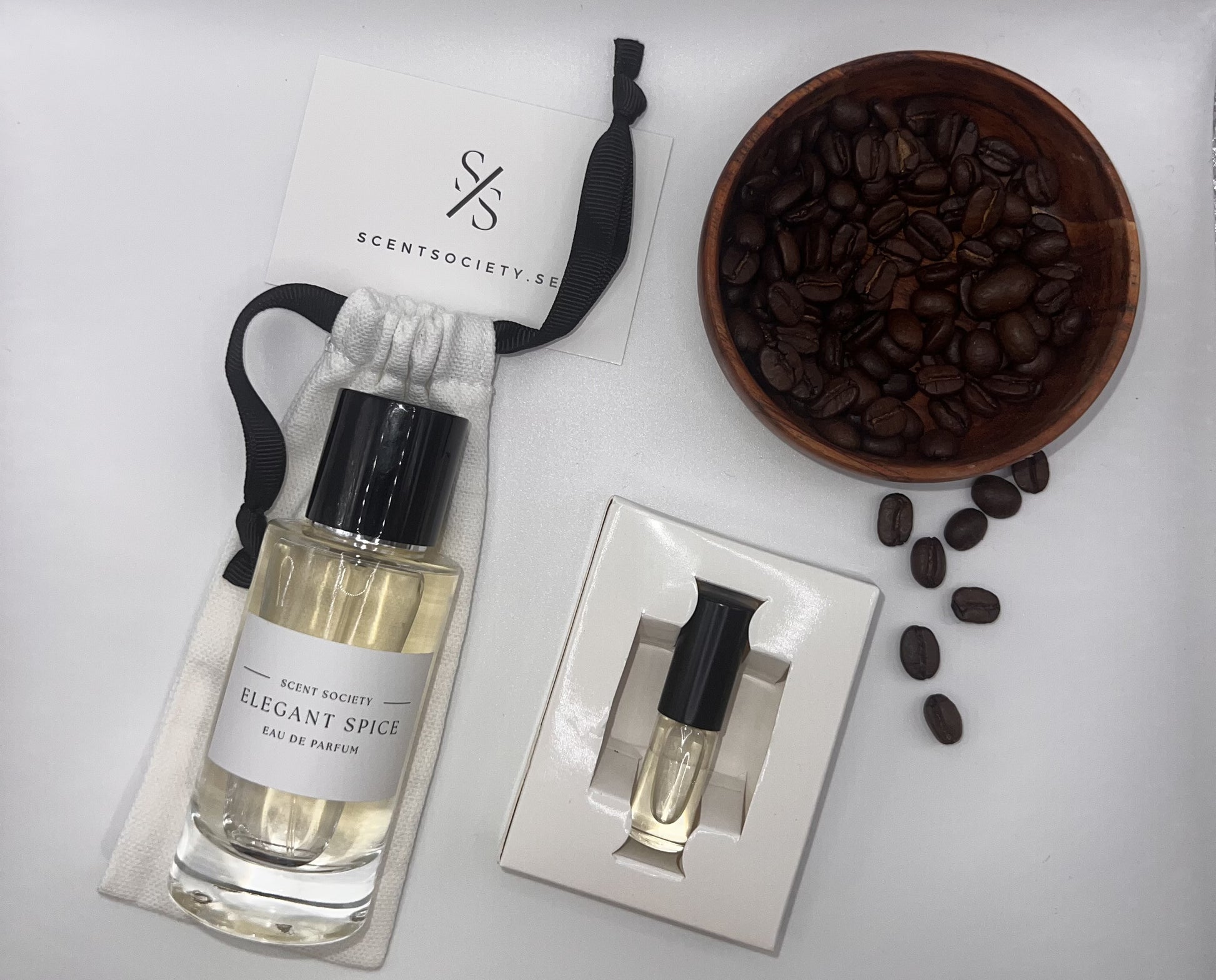 Perfume bottle and gift set with coffee beans representing rich cherry and spicy notes of Spice Touch fragrance by ScentSociety