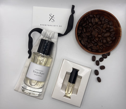Perfume bottle and gift set with coffee beans representing rich cherry and spicy notes of Texas Burn fragrance by ScentSociety