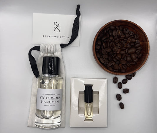Perfume bottle and gift set with coffee beans representing rich cherry and spicy notes of Victorious Hanuman fragrance by ScentSociety