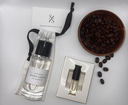 Perfume bottle and gift set with coffee beans representing rich cherry and spicy notes of Warm Amber fragrance by ScentSociety